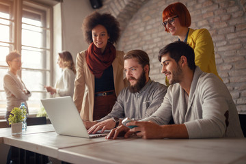 smiling freelance web designers brainstorming.