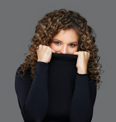 Portrait of young girl covering her face