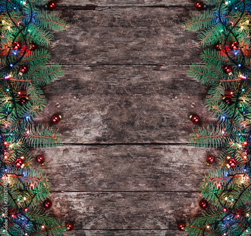 Christmas Fir Branches With Lights And Red Decorations On Wooden Christmas Fir Branches With Lights And Red Decorations On Wooden Background Xmas Hy New