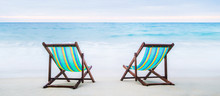 Lounge Chairs On A Tropical Beach. Holidays And Vacation Concept.