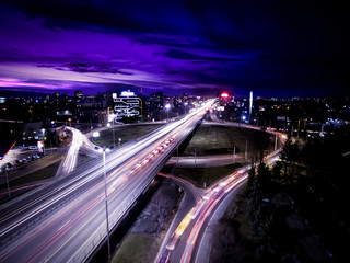 Night aerial view of a main boulevard, a roundabout, office buildings and long exposure car tail lights at Tsarigradsko shose in Sofia, Bulgaria