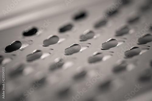 detailed monocrome macro shot of a metal cheese grater Fotobehang