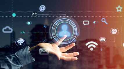 Poster - Businessman holding a Contact icon surrounding by app and social icon - 3d render