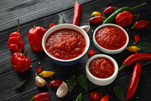 Spicy Hot Sweet Chili Sauce With Mix Of Chilli Pepper, Garlic And Tomatoes On Rustic Wooden Background