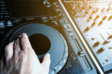 Wall Mural - image of Dj playing music at mixer closeup