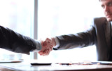 Fototapeta  - close up.a confident handshake of business partners at the desktop
