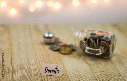 Fotografie, Obraz Donate money concept with shiny coins on a glass jar
