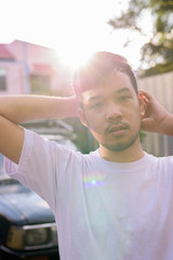 Wall Mural - Young Asian man relaxing in the streets outdoors