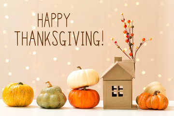 Wall Mural - thanksgiving message with collection of autumn pumpkins with a toy house