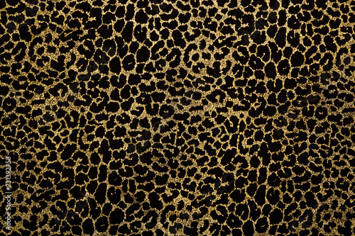 Fotografía Black fabric with golden leopard fur print