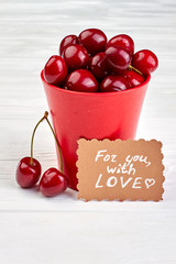 Romantic background with fresh cherries. Red healthy berries in pot. For you with love concept.