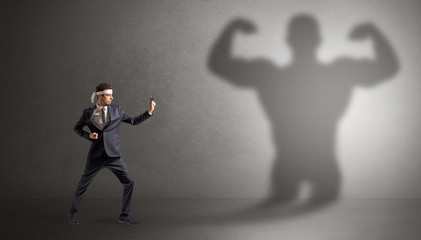 Wall Mural - Young karate man fighting with a big black scary shadow
