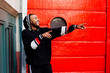 © Carlos David - Portrait of a cool young man in a hoodie pointing at someone with both arms