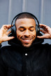© Carlos David - Portrait of young man using headphones