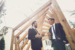 © Yakobchuk Olena - Relaxed young men having free time and smiling while drinking coffee outdoors