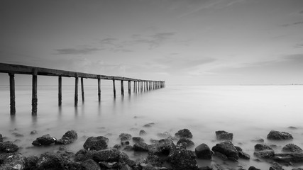 Poster - Old abandoned concrete jetty left alone during sunset.