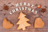 Fototapeta Panele - Inscription Merry Christmas with homemade gingerbreads and cookies for festive time