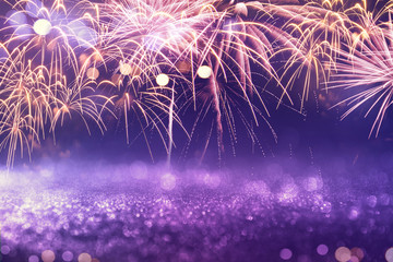 Wall Mural - purple fireworks and bokeh in new year eve and copy space. abstract background holiday.