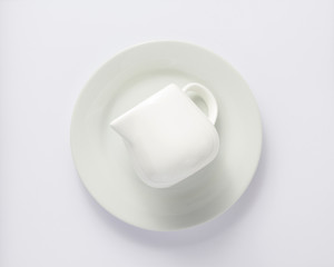 Sticker - empty cream jug at plate on white