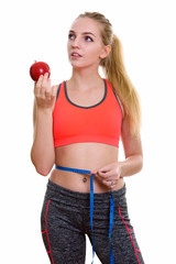 Wall Mural - Young beautiful teenage girl holding red apple while thinking an