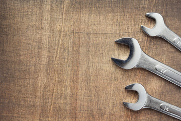 wrench tools at wooden background