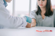 © chompoo - Close up Hand of nurse, doctor or Medical technologist in blue gloves taking blood sample from a patient in the hospital.