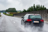 A car on a wet road in the rain. View from the rear through the car window.