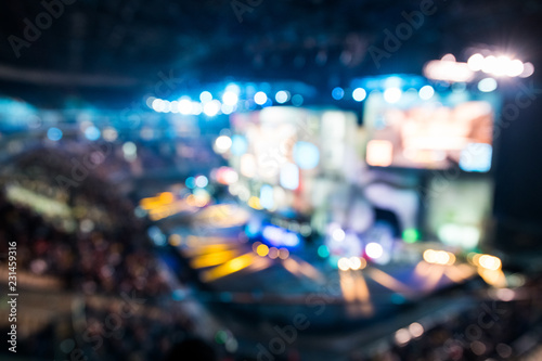 Fotografie, Obraz Blurred background of esports event at big arena with a lot of lights and screens