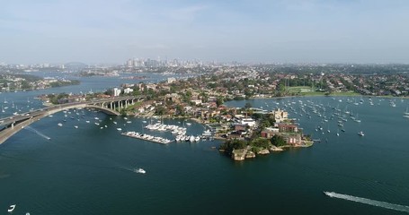 Sticker - Boats under Gladesville bridge on Parramatta river in Sydney Inner West suburbs with distant view of city CBD high-rise towers.
