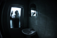 Horror Silhouette Of Woman In Window. Scary Halloween Concept Blurred Silhouette Of Witch In Bathroom. Selective Focus