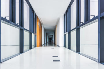 Illuminated long corridor in modern office building