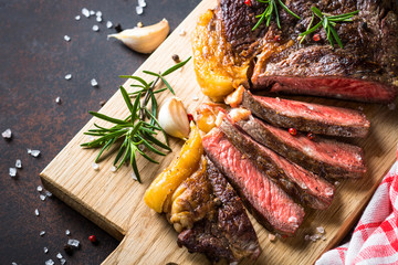 Poster - Grilled beef steak ribeye on wooden cutting board. 