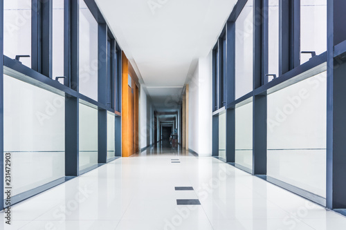 Fotografie, Tablou Illuminated long corridor in modern office building