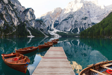 beautiful landscape of braies lake (lago di braies), romantic place with wooden bridge and boats on 