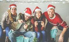 Group Of Happy Friends Having Fun With Video Games Console On Christmas Time