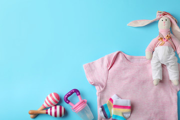 Wall Mural - flat lay composition with stylish baby clothes and toys on color background. space for text