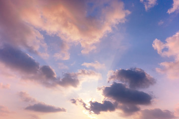 Wall Mural - sunset / sun rise sky with rays of yellow and red light shining clouds and sky background and textur