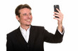 © Ranta Images - Happy Caucasian businessman taking selfie with mobile phone