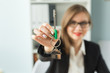 © satura_ - New home and real estate concept - Close up of happy realtor woman with red lips giving you keys from new apartment