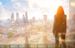 Young woman looking over the City of London at sun set. Future, new business opportunity and business success concept.