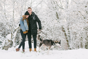 couple with huskies