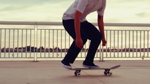 Close Up Slow Motion Of Skateboarder Doing Extreme Flip Trick At Sunset With Lens Flare