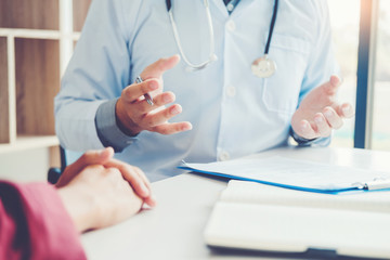 Wall Mural - Doctors and patients sit and talk. At the table near the window in the hospital