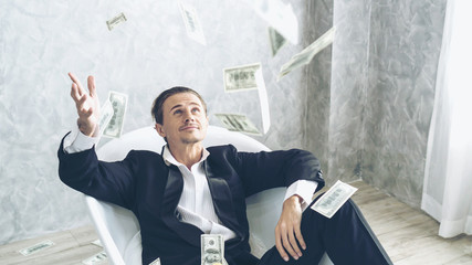 Happy business man very rich guy throw money dollar bills in air like rain money bill and banknotes US dollar bill on the bathtub - business success concept