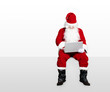 © Tom Wang - santa claus watching laptop and sitting on blank panel