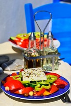 Greek Salad With Sheep Cheese Served On Plate, Vinegar And Oil On The Back, Greek Tavern, Mirtos, Crete, Greece, Europe