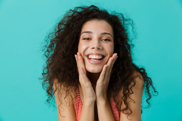 Canvas Print - Image of excited woman 20s wearing casual clothing laughing, standing isolated over blue background