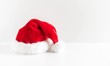 © prime1001 - Santa Claus red hat on wooden white background. space for text