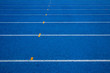 © kanpisut - Blue running track in stadium. rubber running tracks in outdoor stadium.