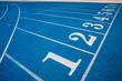 © kanpisut - Blue running track in stadium. rubber running tracks in outdoor stadium.